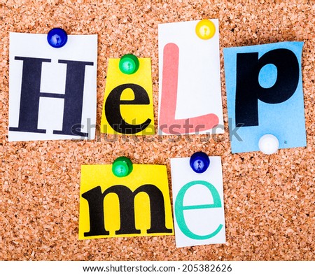 The phrase Help me  in cut out magazine letters pinned to a cork notice board