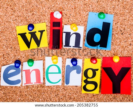 The phrase wind energy  in cut out magazine letters pinned to a cork notice board