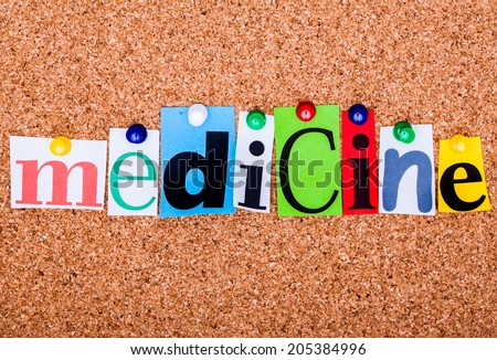 The word medicine in cut out magazine letters pinned to a cork notice board