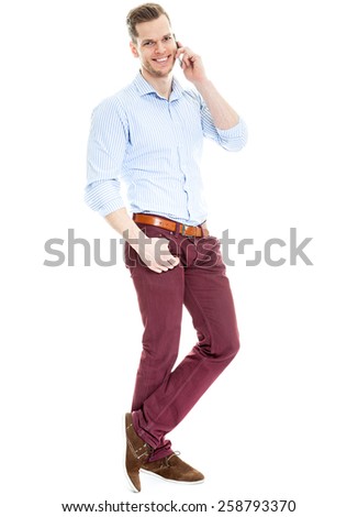 young man talking on the phone - full length shot isolated