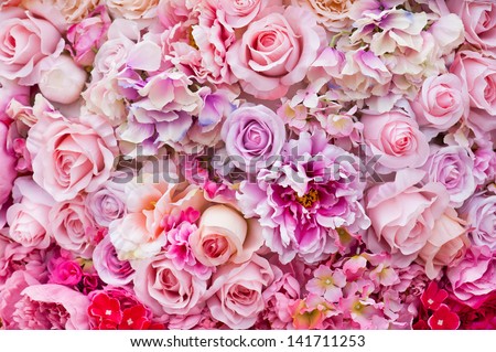 Floral background. Lot of artificial flowers in colorful composition