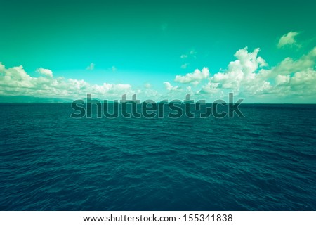 Sea landscape with blue sky and clouds. Traveling background in vintage style