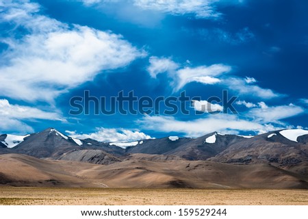 Himalaya high mountain landscape panorama with blue cloudy sky. India, Ladakh, near salt lake Tso Kar, altitude 4600 m