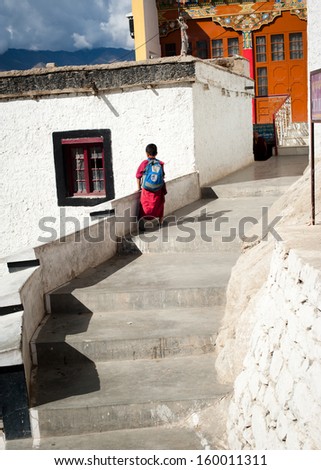 THIKSEY, INDIA - SEPTEMBER 13: Unidentified tibetan boy, novice monk, student of Buddhist school at Thiksey monastery, going to classroom on September 13, 2012 in Thiksey Gompa, Leh, Ladakh, india
