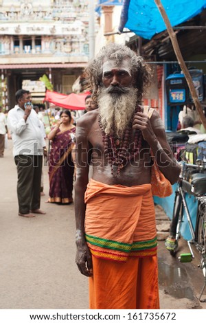 TRICHY, INDIA - FEBRUARY 14: Holy Sadhu men with traditional painted face and dreadlocks at crowded street near Sri Ranganathaswamy Temple on Febr 14, 2013. South India, Tamil Nadu, Thanjavur (Trichy)