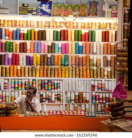 Madurai, India - February 16: Indian Man Selling Souvenirs And Colorful Bangles At Market Place Inside Meenakshi Temple On February 16, 2012. India, Madurai, Tamil Nadu