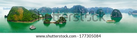 Tourist junks floating among limestone rocks at early morning in Ha Long Bay, South China Sea, Vietnam, Southeast Asia. Ten vertical images panorama