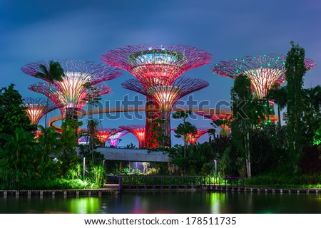 SINGAPORE -DEC 31: Futuristic view of amazing illumination at Garden by the Bay on Dec 31, 2013 in Singapore. Night light show at Supertree Groveis is main Marina Bay Sands district tourist attraction