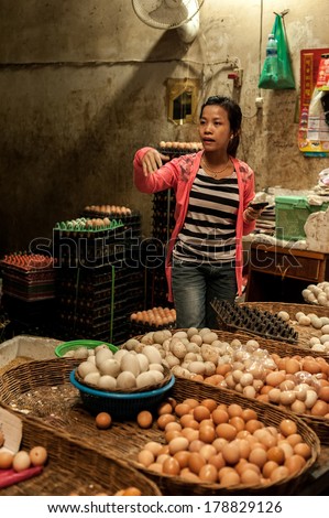 SIEM REAP, CAMBODIA - DEC 22, 2013: Unidentified Khmer woman selling eggs at traditional food marketplace on Dec 22, 2013 in Siem Reap, Cambodia. Street food markets is popular tradition in asia