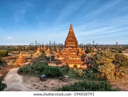 Travel landscapes and destinations. Tourists horse carriage in front of ancient Mahazedi Pagoda. Amazing architecture of old Buddhist Temples at Bagan Kingdom, Myanmar (Burma)