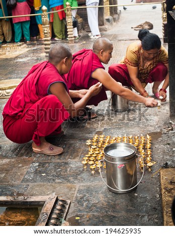 KATHMANDU, NEPAL - SEPTEMBER 18: Buddhist monks providing religious ceremony and blessing people at Buddhist Shrine Swayambhunath Stupa named Monkey Temple on September 18, 2012. Nepal, Kathmandu