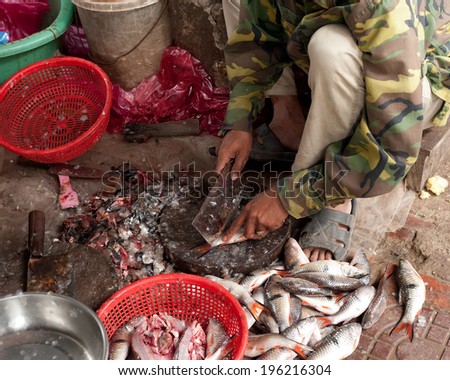 Selling fish at traditional asian seafood marketplace in Siem Reap, Cambodia