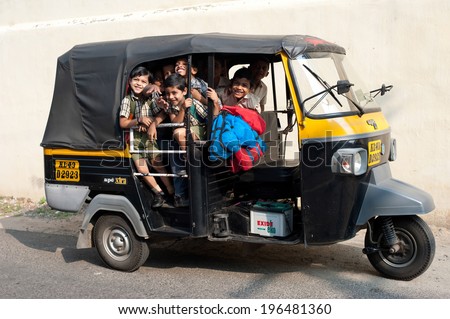 KOCHI, INDIA - FEBRUARY 25: Unidentified school children in uniform going home after classes at primary school by a rickshaw on February 25, 2013. India, Cochin (Kochi),  Kerala