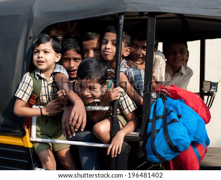 KOCHI, INDIA - FEBRUARY 25: Unidentified school children in uniform going home after classes at primary school by a rickshaw on February 25, 2013. India, Cochin (Kochi),  Kerala
