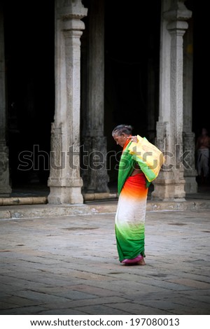 MADURAI, INDIA - FEBR 16: Indian woman in colorful sari carrying bale with offerings for  religious ritual at Meenakshi Temple holy place for hindu people on Febr 16, 2013. India, Madurai, Tamil Nadu