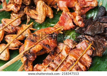 Traditional asian food at market. Delicious spicy grilled chicken meat on sticks