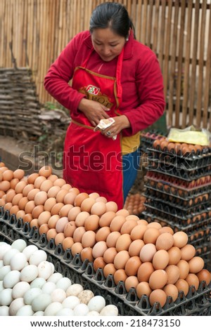 LUANG PRABANG, LAOS - DEC 8: Unidentified woman selling eggs at traditional asian food marketplace on Dec 8, 2013 in Luang Prabang, Laos