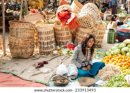 BAGAN, MYANMAR - JANUARY 16, 2014: Burmese woman selling spices and local goods at traditional asian marketplace. Burma travel destinations