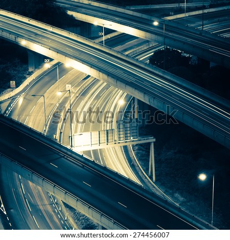 Abstract night view of highway interchange with moving cars. Hong Kong city aerial background in vintage style