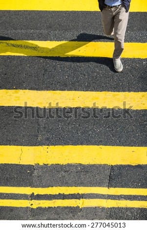 Pedestrians people moving at zebra crosswalk. Hong Kong. Crowded city abstract background