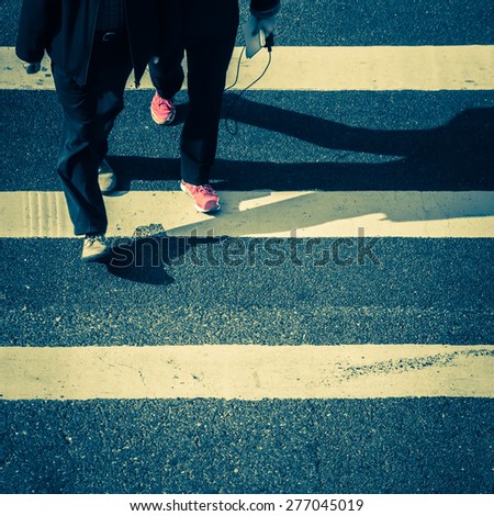 Vintage style image of pedestrians people moving at zebra crosswalk. Hong Kong. Crowded city abstract background