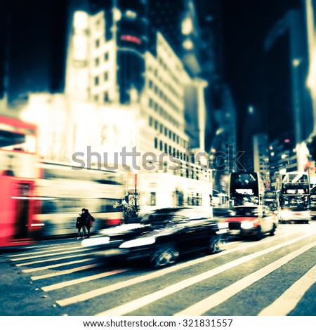Abstract cityscape blurred background, art toning. Night view of modern city street with moving transport and illuminated skyscrapers. Hong Kong