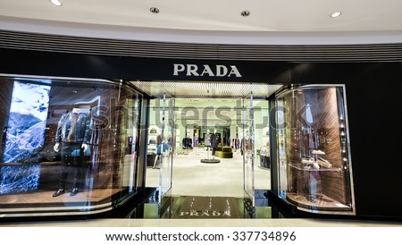 HONG KONG - 23 JAN, 2015: Prada boutique display window with luxury clothes and accessories. Italian luxury fashion house produces shoes, luggage, perfumes, watches.  Ffounded in 1913 by Mario Prada