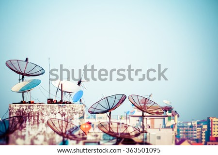 Tilt shift blur effect. Abstract Yangon cityscape with parabolic satellite dishes at building roofs. Myanmar (Burma) travel landscapes and destinations