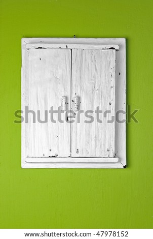 Decorative photo frame, door imitating. Old wooden door, white painted, on green painted wall