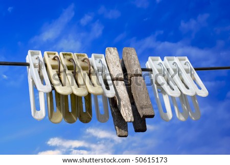 Laundry. Clothes pegs on rope against blue sky background