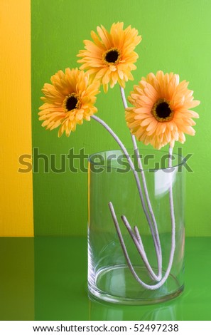 yellow artificial silk flowers over multicoloredpainted wall