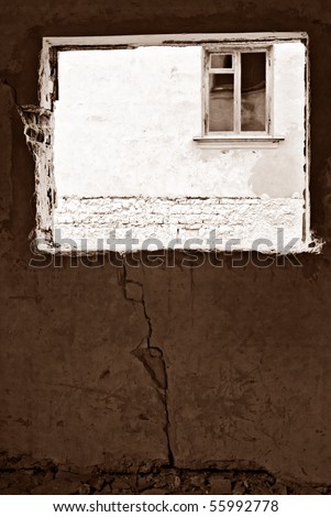 Windows. View at old broken house facade with window through window aperture in old abandoned house. Vintage imitating image, sepia tinted