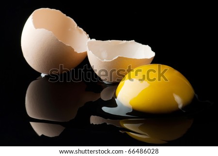 Broken egg on black