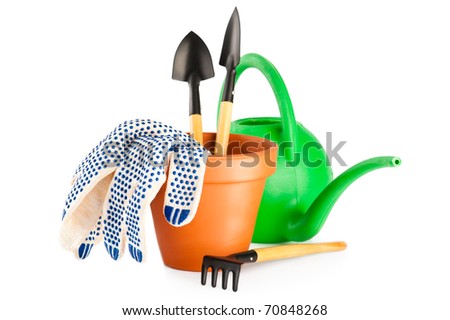Garden tools and terracotta flower pot with gloves isolated on white background