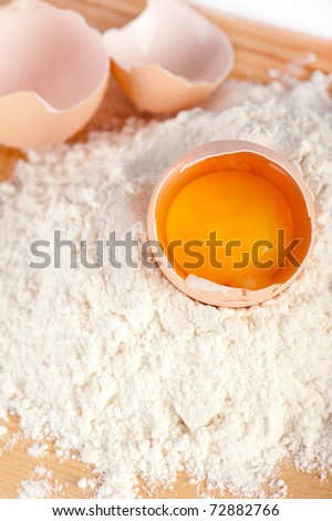Bakery ingredient. Flour with eggs for bakery on wooden background