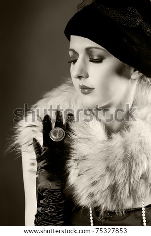 Retro styled fashion portrait of a young woman in gloves. Clothing and make-up in vintage style - stock photo
