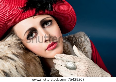 Retro style imitating fashion portrait of a young woman in red hat. Clothing and make-up in vintage style
