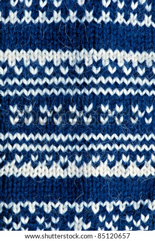 Knit woolen texture. Fabric blue and white background