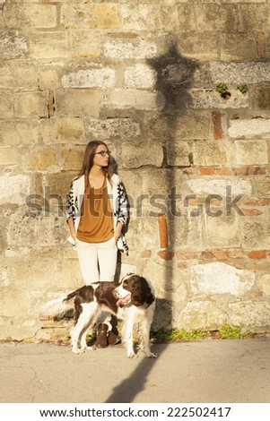 Young Girl Leaning on Brick Wall With Dog Outdoor With Shadow Of Lamp