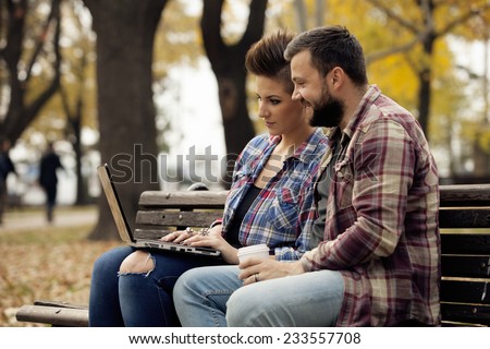 Young Urban People Outdoor Using Laptop Computer In Autumn Fall Park