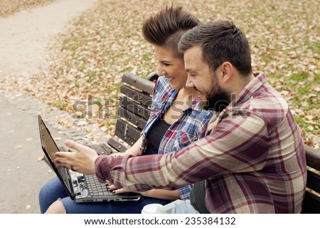 Young Urban People Outdoor Using Computer Laptop And Drinking Coffee From To Go Cup