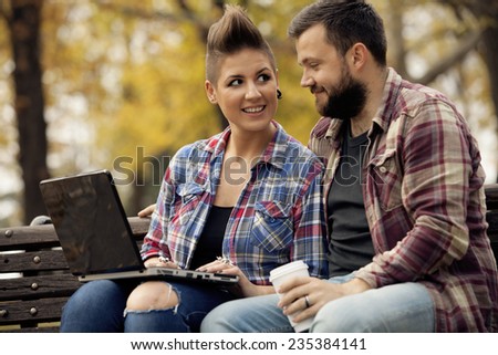 Young Urban People Outdoor Using Computer Laptop And Drinking Coffee From To Go Cup