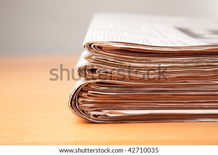 stack of newspapers on table