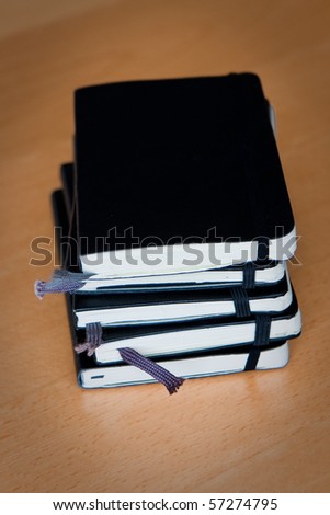 stack of black notebooks