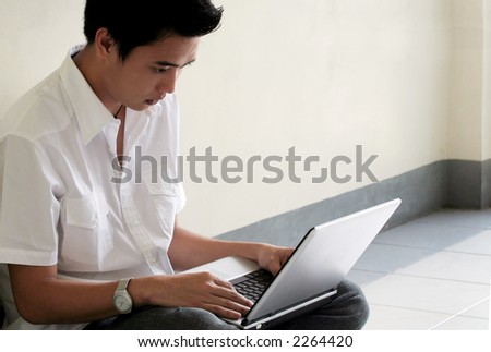 Asian Student working with Laptop