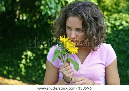 a pretty woman, pulls a pedal from a flower