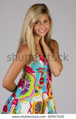 stock photo a pretty blond teen girl wearing a colorful party dress