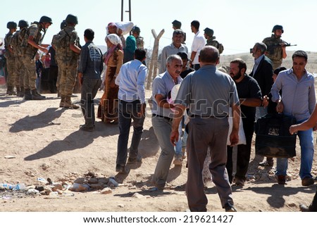 SURUC, TURKEY-SEPTEMBER 20, 2014: Turkey opened its border to Syrians fleeing the town of Kobane in fear of an Islamic State attack. Tens of thousands have fled to Turkey on september 20, 2014.