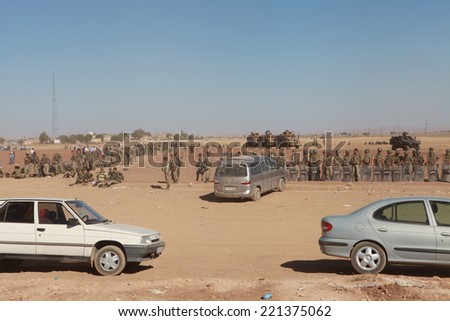SURUC, TURKEY-SEPTEMBER 21, 2014: Turkey opened its border to Syrians fleeing the town of Kobane in fear of an Islamic State attack. Turkish soldiers at the border. On september 21, 2014.