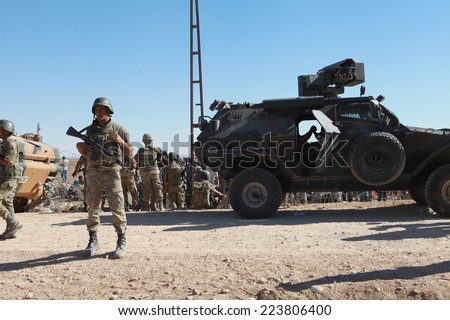 SURUC, TURKEY-SEPTEMBER 21, 2014: Turkey opened its border to Syrians fleeing the town of Kobane in fear of an Islamic State attack. Turkish soldiers at the border. on september 21, 2014.